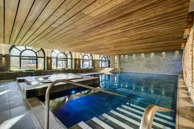 a large swimming pool with a wooden ceiling at California in Chamonix-Mont-Blanc