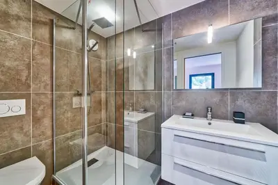 a bathroom with a sink and a toilet and a mirror at California in Chamonix-Mont-Blanc