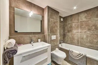 a bathroom with a sink and a toilet and a mirror at California in Chamonix-Mont-Blanc