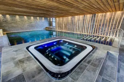 a swimming pool with a hot tub in a house at California in Chamonix-Mont-Blanc
