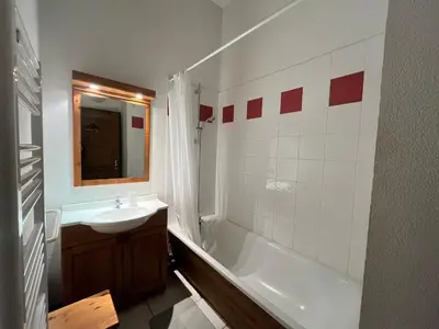 a bathroom with a white tub and a sink and a bath tub at Chalet 3 chambres avec piscine et parking à Samoëns - FR-1-624-111 in Samoëns