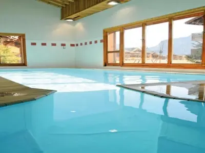 an empty swimming pool with blue floors and windows at Chalet 3 chambres avec piscine et parking à Samoëns - FR-1-624-111 in Samoëns