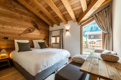 a bedroom with a bed and a wooden ceiling at Apartment Celosia Chamonix - by EMERALD STAY in Chamonix-Mont-Blanc