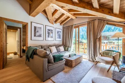 a living room with a couch and a table at Apartment Celosia Chamonix - by EMERALD STAY in Chamonix-Mont-Blanc