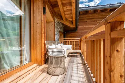 a porch with a bench on a wooden deck at Apartment Celosia Chamonix - by EMERALD STAY in Chamonix-Mont-Blanc