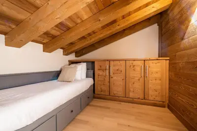 a room with a bed and wooden ceilings at Apartment Celosia Chamonix - by EMERALD STAY in Chamonix-Mont-Blanc