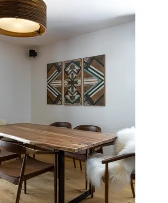 a dining room with a wooden table and chairs at Apache_Coudriers in Megève
