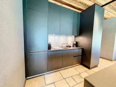 a kitchen with stainless steel cabinets and a sink at LES ALPES III in Chamonix-Mont-Blanc
