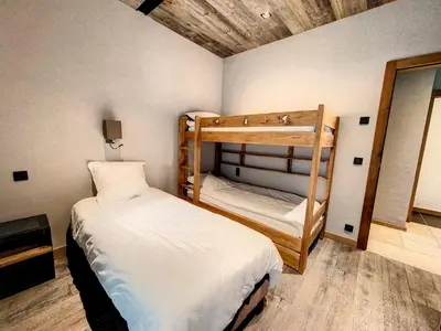 a bedroom with two bunk beds in a room at LES ALPES III in Chamonix-Mont-Blanc