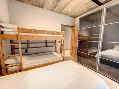 a room with two bunk beds in a room at LES ALPES III in Chamonix-Mont-Blanc