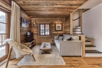 a living room with a couch and a table at Chalet 3 étoiles pour 4 pers avec vue imprenable sur la vallée de Chamonix in Les Houches