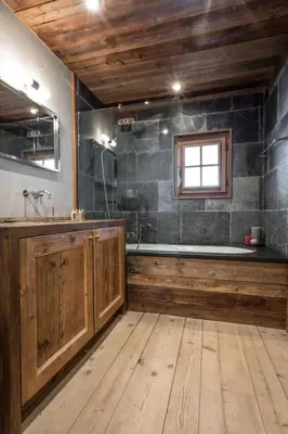 a large bathroom with a tub and a sink at Chalet l'Ourson, avec jacuzzi, sauna, services hôteliers in Chamonix-Mont-Blanc