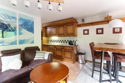 a living room with a couch and a table at Le Grand Tetras - Beside Lake Chavants, TMB staring point & Hikes in Les Houches