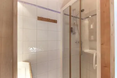 a bathroom with a shower with a glass door at Le Grand Tetras - Beside Lake Chavants, TMB staring point & Hikes in Les Houches