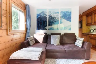 a living room with a brown leather couch at Le Grand Tetras - Beside Lake Chavants, TMB staring point & Hikes in Les Houches