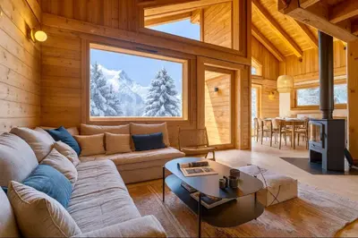 a living room with a couch and a table at Sublime Semi Detached Chalet Facing The Mont Blanc in Chamonix-Mont-Blanc