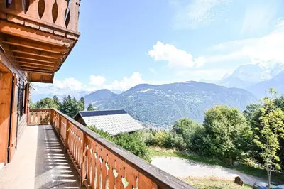 a balcony of a house with a view of mountains at Nice Peaceful Cottage With Garden And Balcony in Saint-Gervais-les-Bains