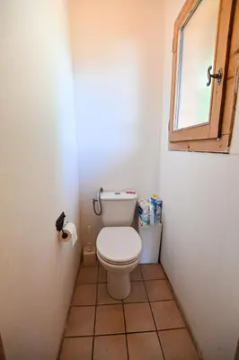 a small bathroom with a toilet and a window at Nice Peaceful Cottage With Garden And Balcony in Saint-Gervais-les-Bains