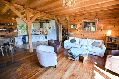 a living room with a couch and chairs in a cabin at Nice Peaceful Cottage With Garden And Balcony in Saint-Gervais-les-Bains