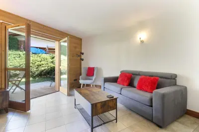 a living room with a couch and a table at Les Granges des Bossons in Chamonix-Mont-Blanc