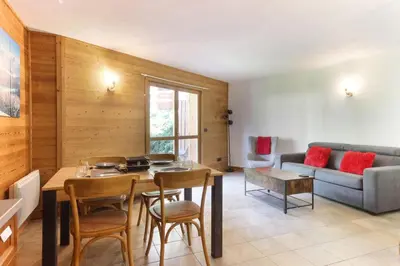 a living room with a table and a couch at Les Granges des Bossons in Chamonix-Mont-Blanc