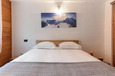 a bedroom with a bed with two white pillows at Les Granges des Bossons in Chamonix-Mont-Blanc