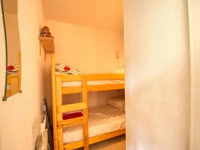 a bunk bed in a small room with a ladder at Appartement de 60 m² pour 6 personnes, pied des pistes - FR-1-642-71 in Morillon