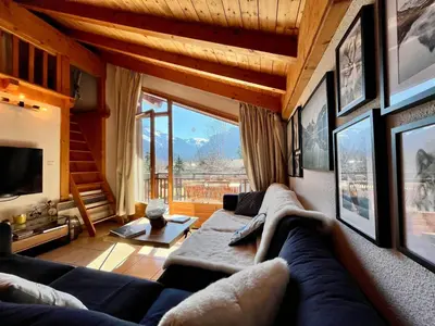a living room with a couch and a large window at Appartement chaleureux avec balcon près du centre - FR-1-624-112 in Samoëns