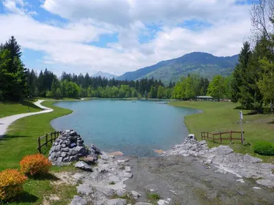 a lake in a field next to a road at Appartement neuf avec balcon et navette pour le ski - FR-1-624-113 in Samoëns