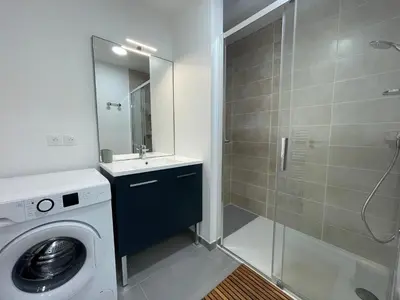 a bathroom with a washing machine and a shower at Appartement neuf avec balcon et navette pour le ski - FR-1-624-113 in Samoëns