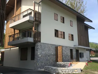 a building with balconies on the side of it at Appartement neuf avec balcon et navette pour le ski - FR-1-624-113 in Samoëns