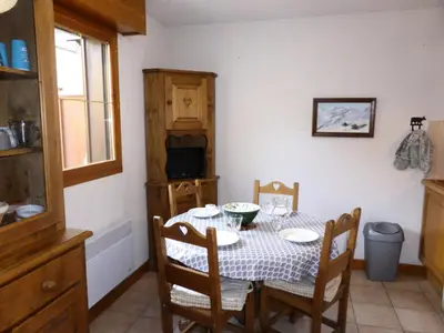 a dining room with a table and chairs and a television at Résidence Palmes D'or - Palmes d'Or B109 MAE-5504 in Les Contamines-Montjoie