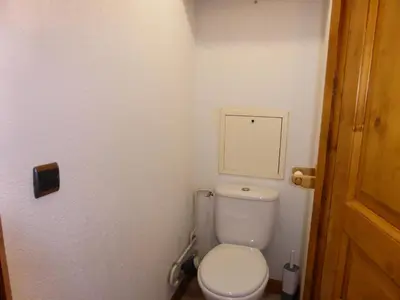 a small bathroom with a toilet and a door at Résidence Palmes D'or - Palmes d'Or B109 MAE-5504 in Les Contamines-Montjoie