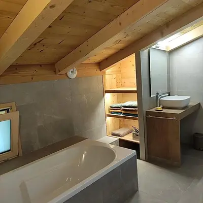 a bathroom with a bath tub and a sink at Chalet récent vue panoramique sur le MONT-BLANC in Combloux