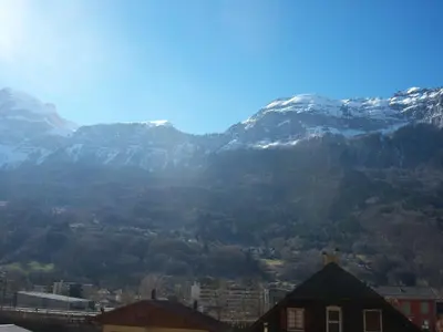 a view of a mountain range with snow covered mountains at Hotel Edelweiss in Magland