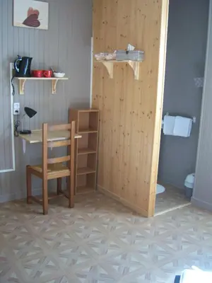 a room with a table and a chair and a desk at Hotel Edelweiss in Magland