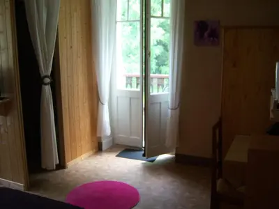 a room with a door and a pink rug at Hotel Edelweiss in Magland