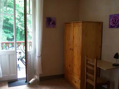 a room with a wooden cabinet next to a window at Hotel Edelweiss in Magland