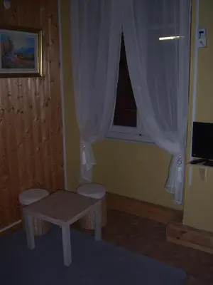 a small room with a table and a window at Hotel Edelweiss in Magland