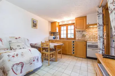 a kitchen with a bed and a table in a room at Chalet spacieux à Saint-Gervais-les-Bains avec vue montagne in Saint-Gervais-les-Bains