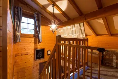 a room with a staircase in a cabin with a window at Chalet spacieux à Saint-Gervais-les-Bains avec vue montagne in Saint-Gervais-les-Bains