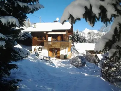 a log home in the snow with snow covered trees at Chalet spacieux à Saint-Gervais-les-Bains avec vue montagne in Saint-Gervais-les-Bains