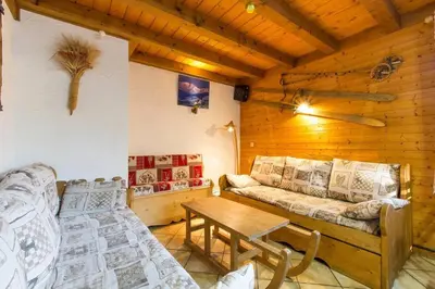 a living room with a couch and a table at Chalet spacieux à Saint-Gervais-les-Bains avec vue montagne in Saint-Gervais-les-Bains