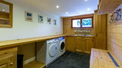 a laundry room with a washing machine and a sink at Chalet Birdie in Les Houches