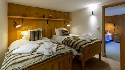 a bedroom with two beds with towels on them at Chalet Birdie in Les Houches