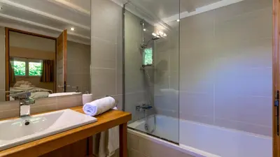 a bathroom with a tub and a sink and a shower at Chalet Birdie in Les Houches