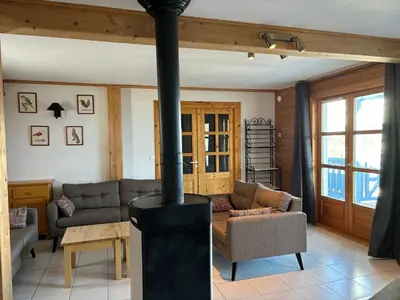 a living room with a wood burning stove at Chalet lumineux · Sauna privatif · Garage · 12 personnes - FR-1-425-119 in Arâches-la-Frasse