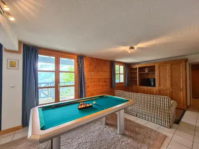 a living room with a pool table in it at Chalet lumineux · Sauna privatif · Garage · 12 personnes - FR-1-425-119 in Arâches-la-Frasse