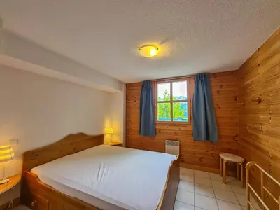 a bedroom with a large bed and a window at Chalet lumineux · Sauna privatif · Garage · 12 personnes - FR-1-425-119 in Arâches-la-Frasse