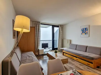 a living room with a couch and a tv at Studio lumineux proche des pistes avec balcon - FR-1-425-169 in Arâches-la-Frasse